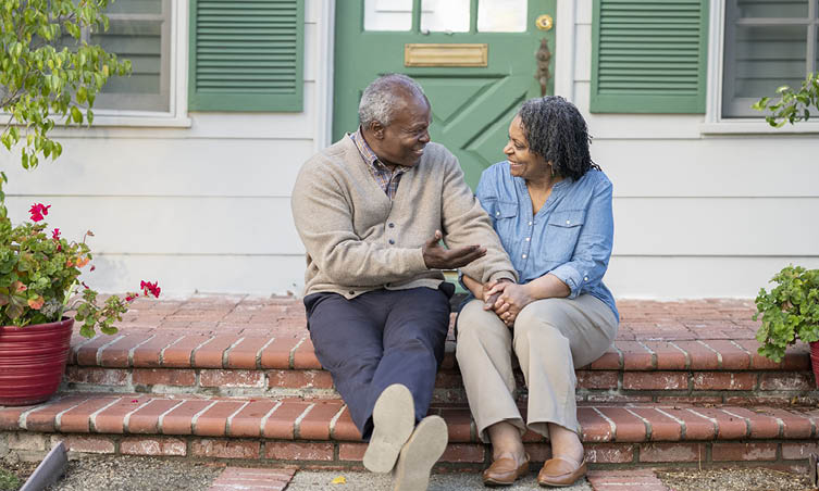 Older Black man and woman looking at each other