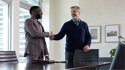 Promoted employee shaking manager's hand