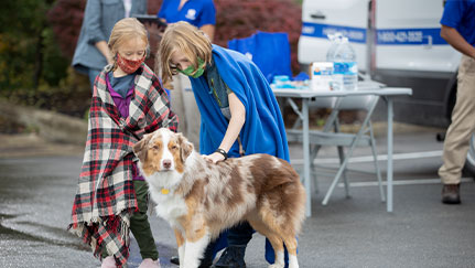 two kids petting a dog