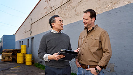 man and Nationwide employee discussing paperwork