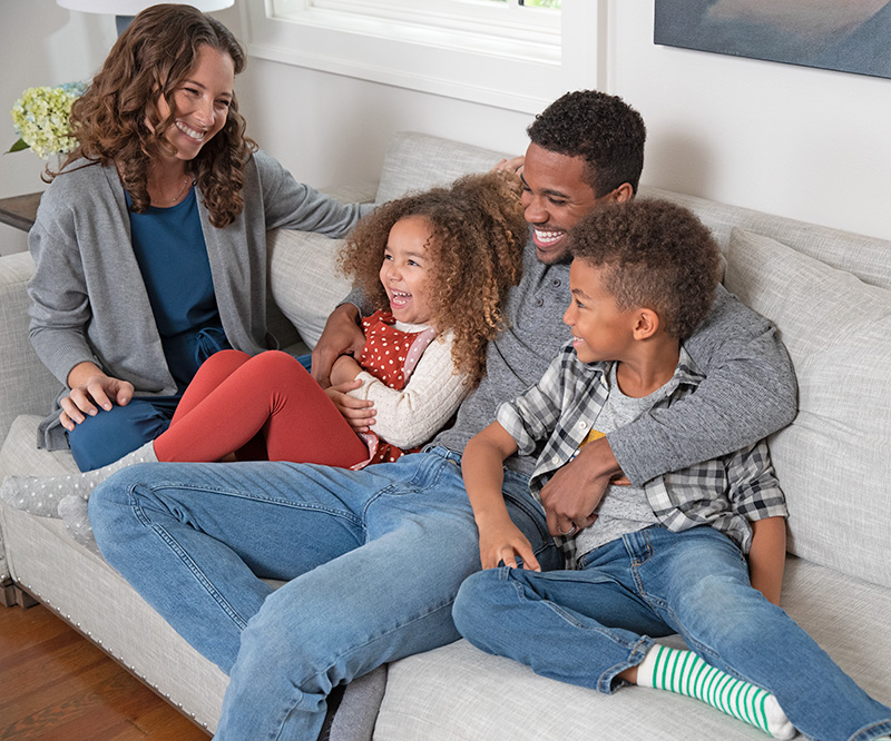 family cuddling on couch